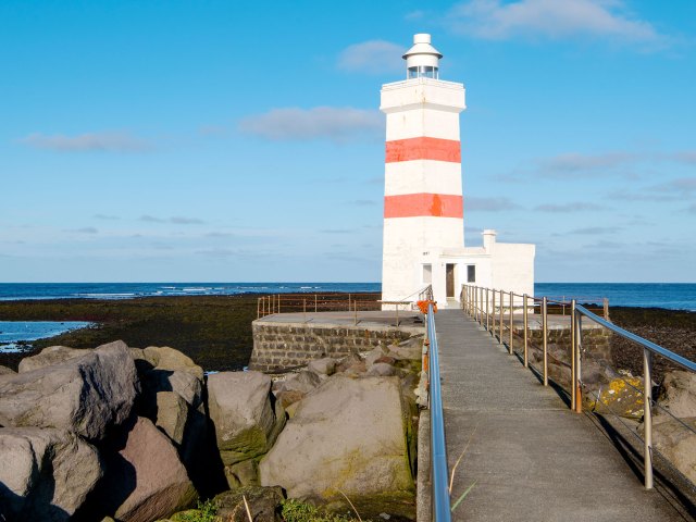 Lighthouse on rocky coast of Iceland