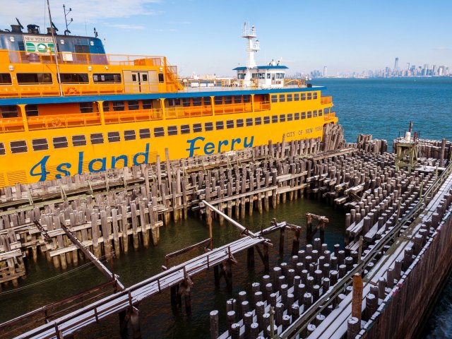 Yellow-painted Staten Island Ferry at dock