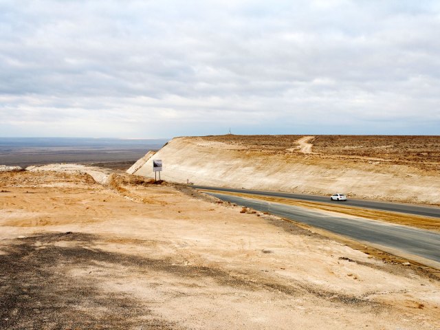Road through landscape of Vpadina Kaundy in Kazakhstan