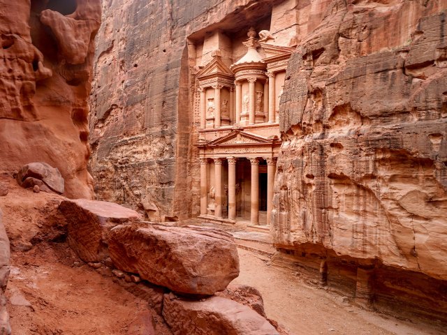 Building carved into sandstone facade of Petra, Jordan