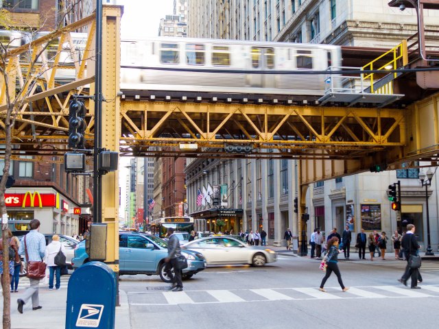 Chicago "L" train on elevated tracks above busy street