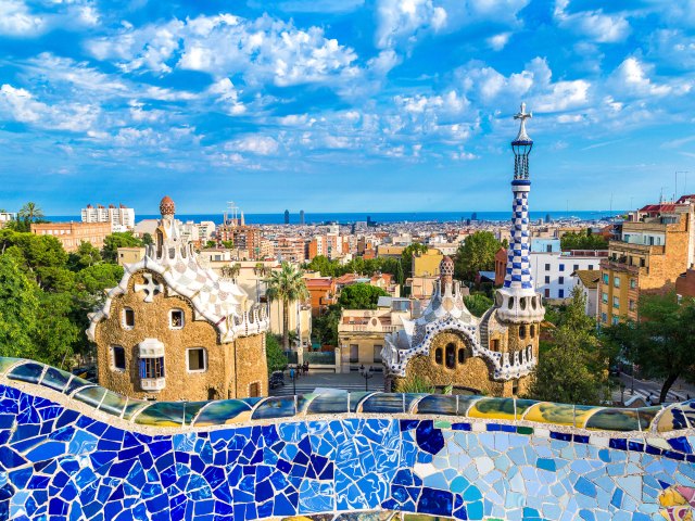 Blue-tiled wall overlooking Barcelona skyline at Park Güell