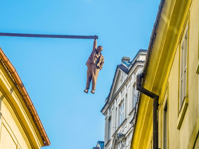 "Man Hanging Out" statue dangling over streets of Prague, Czechia