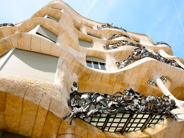 Looking up at the curvy, whimsical facade of Casa Milà