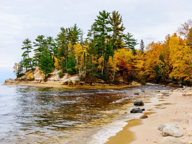 Beach in Munising, Michigan, with fall foliage
