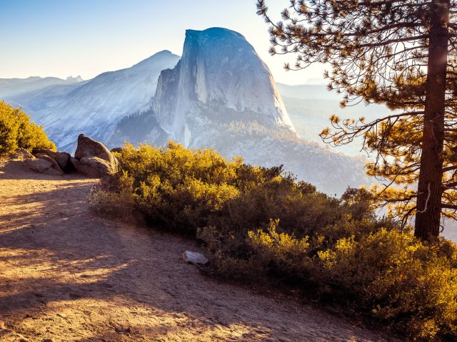 Vista of Half Dome granite rock formation in the distance in Yosemite National Park