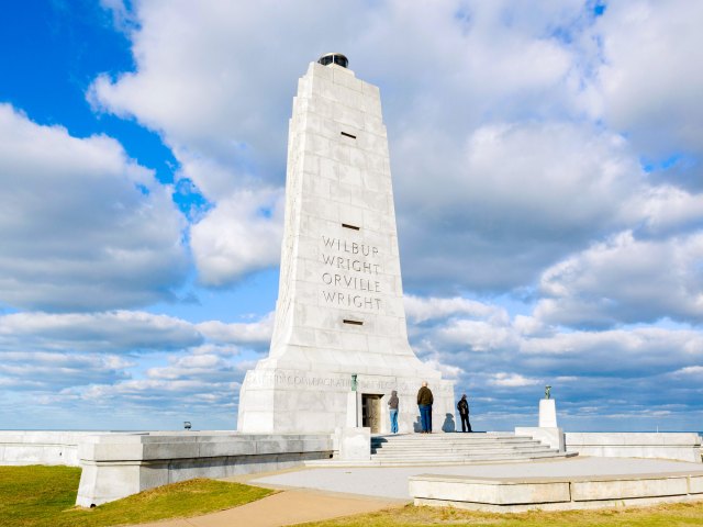 Tall white statue dedicated to the Wright Brothers at Wright Brothers national Memorial in North Carolina