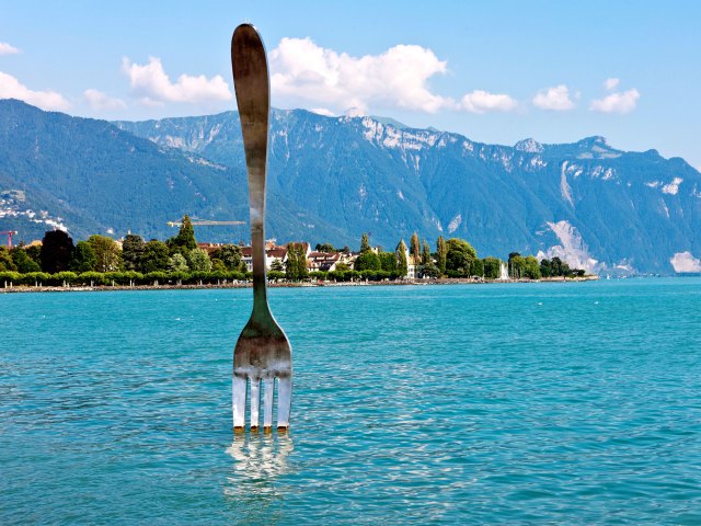Giant fork statue of "La Fourchette" poking out of Lake Geneva in Vevey, Switzerland