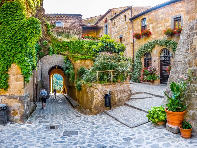 Narrow cobblestone streets and archways in village of Civita di Bagnoregio, Italy