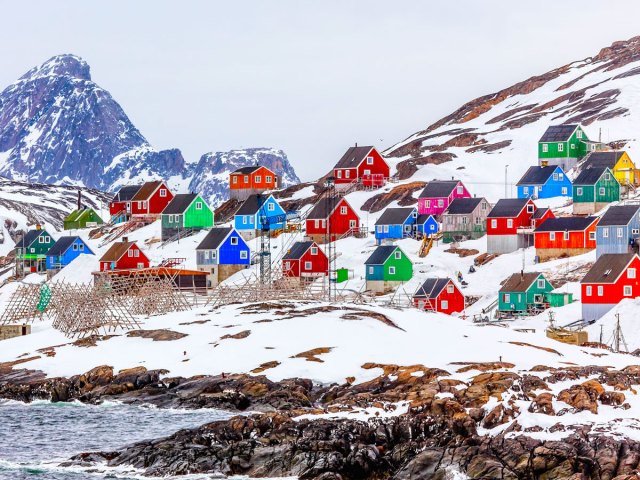 Colorful homes on snowy coastline of Greenland