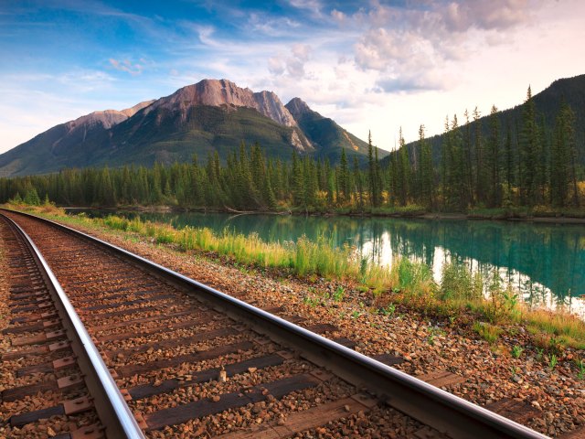 Empty track of the Trans Canada Railway through mountainous landscape