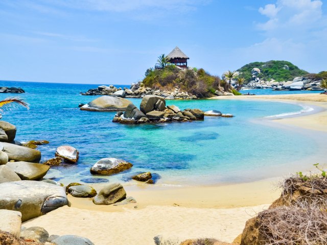 Sandy coastline strewn with boulders in Colombia