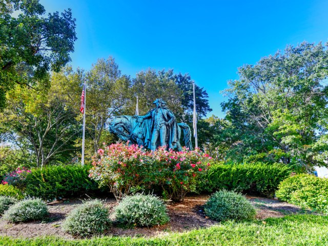 Statue of George Washington surrounded by trees and flowers in Newark's Washington Park