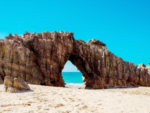Rock arch on beach in Jericoacoara National Park in Brazil