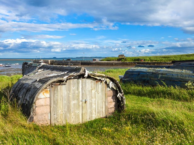 Upturned boat houses used for storage on Holy Island, England