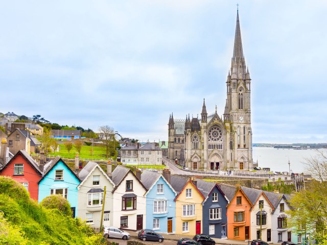 Cathedral and row of colorful homes in Cobh, Ireland