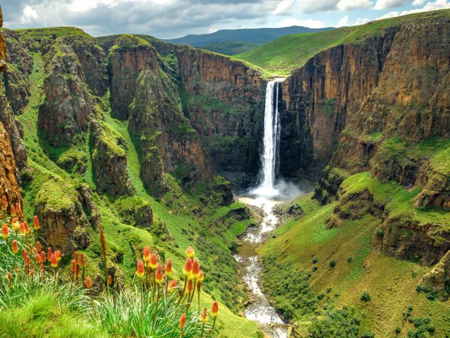 Aerial view of a waterfall and lush countryside of Lesotho