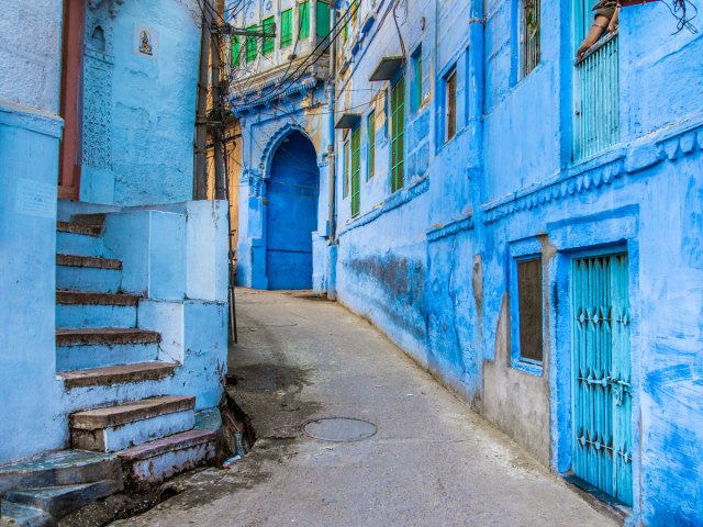 Narrow alleyway between blue buildings in Jodhpur, India