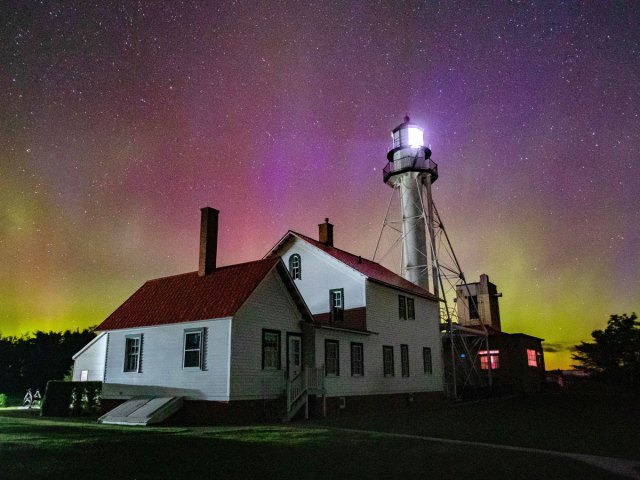 Aurora borealis lighting up night sky in Upper Peninsula, Michigan