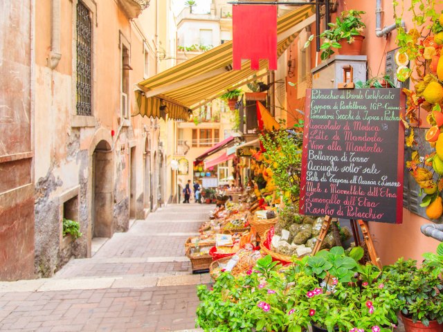 Narrow alley lined with shops in Taormina, Sicily