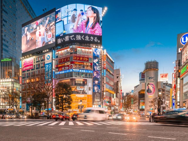 Time lapse of billboards and traffic at Shibuya Crossing at night