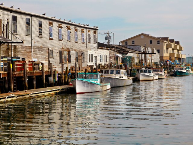 Ships docked along harborfront buildings in Portland, Maine