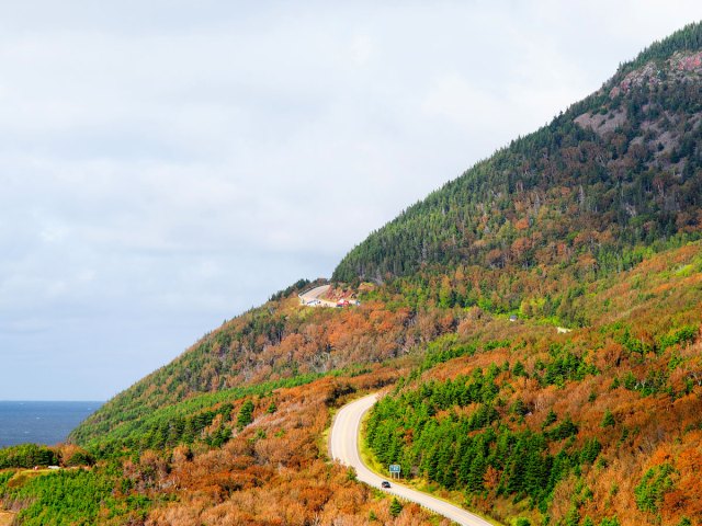 Roadway winding through autumn foliage on the Cabot Trail in Nova Scotia