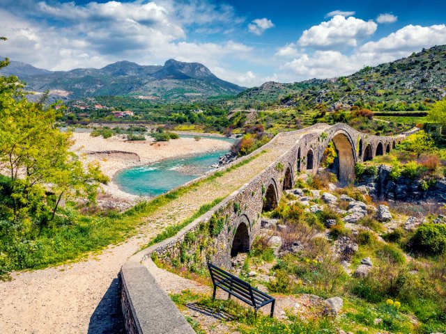 Stone arch bridge in mountains of Albania, seen from above