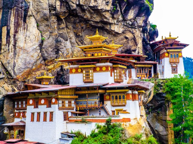 Gold-and-white Tiger's Nest Monastery perched on hillside in Bhutan