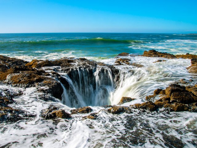 Waters of Pacific Ocean draining into Thor's Well, Oregon