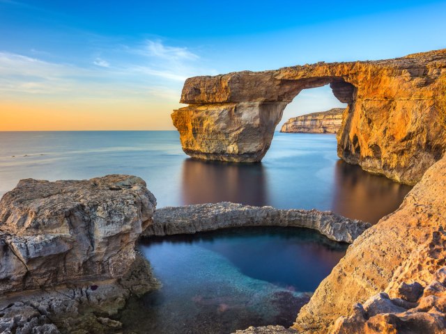 Natural stone arch over the Mediterranean Sea along the coastline of Malta