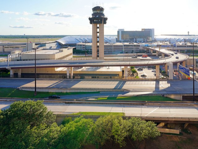 Aerial view of control tower, roadway complex, and passenger terminals at Dallas/Fort Worth International Airport