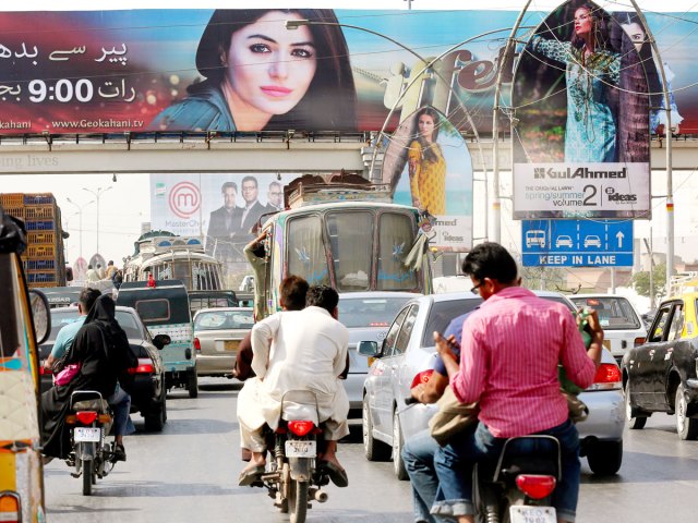 Busy street lined with billboards in Karachi, Pakistan