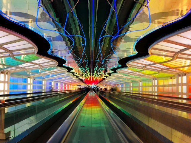 Escalator tunnel under neon light display at Chicago O'Hare International Airport