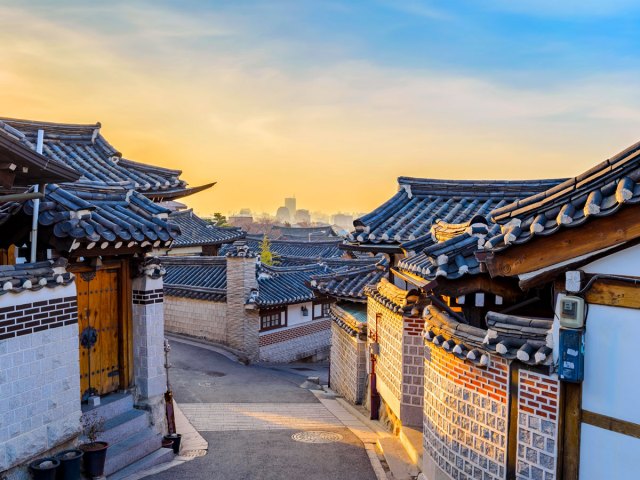 Traditional homes lining curving, sloped street in Seoul, South Korea
