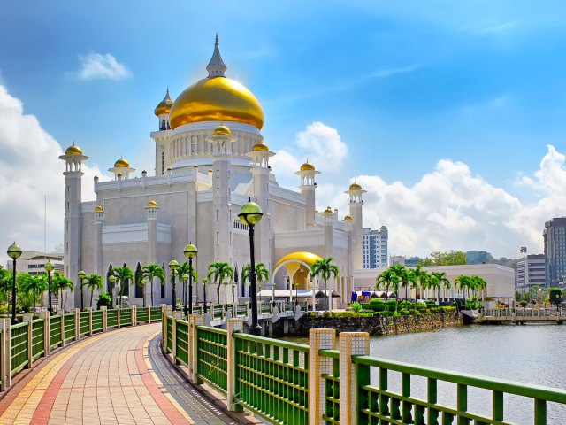 Bridge leading to gold-domed temple in Brunei