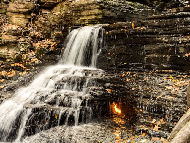 Small flame behind waterfall in New York's Erie County