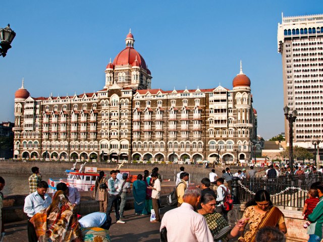 People in front of the Taj Mahal Palace hotel in Mumbai, India