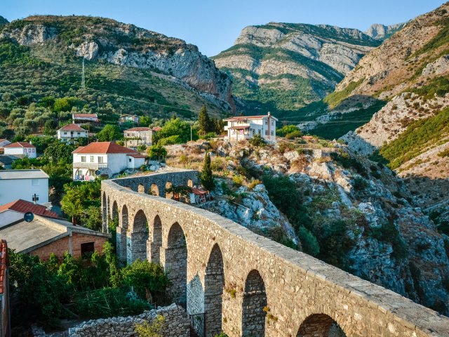 Stone arch bridge in valley in Montenegro, seen from above