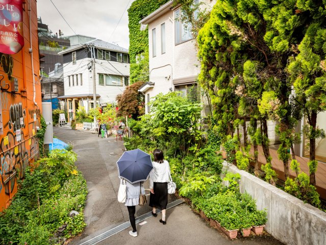 Couple walking down residential street in Tokyo, Japan