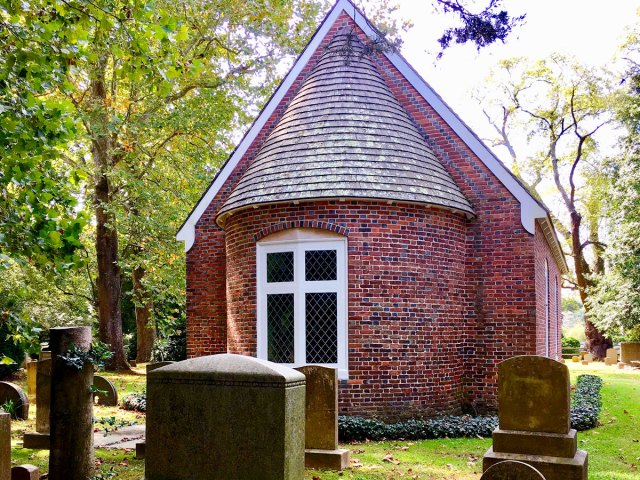 Tombstones in front of brick exterior of Old Trinity Church in Maryland