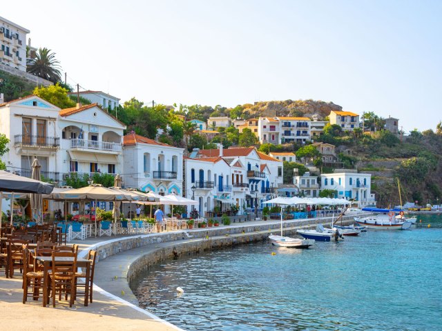 Waterfront buildings and cafe tables in Ikaria, Greece