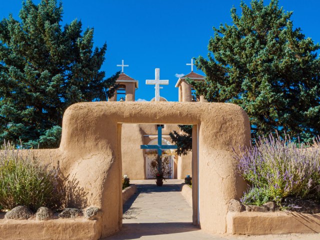 Adobe archway leading to church in Taos Pueblo
