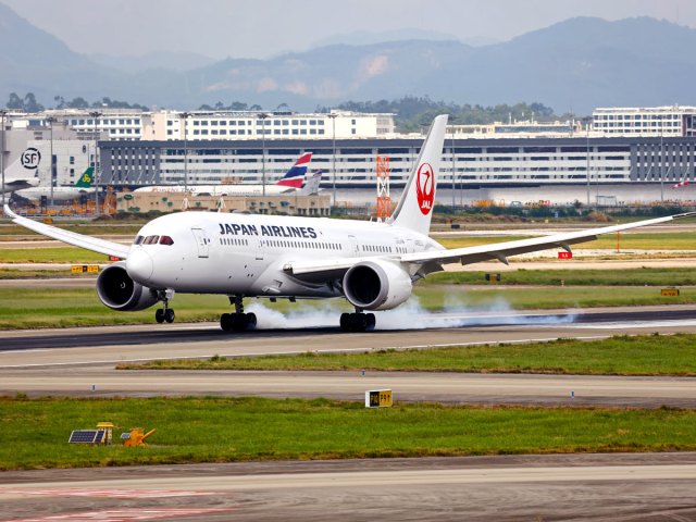 Japan Airlines airplane landing on runway