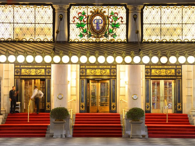 Steps to the lobby of the Plaza Hotel in New York City lit at night