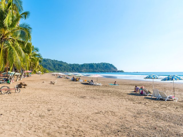 Beach goers on sandy beach in Nicoya, Costa Rica