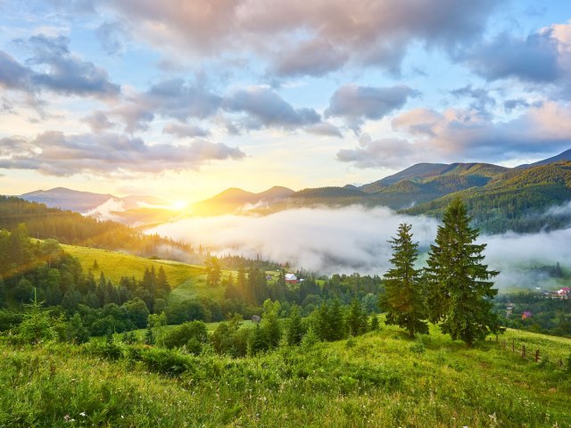 Low clouds over mountain valley at sunrise