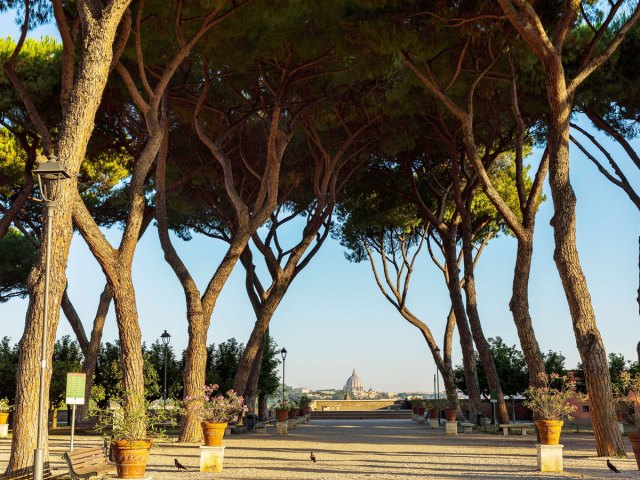 Tree-lined pathway in Giardino degli Aranci with view of Rome in the distance