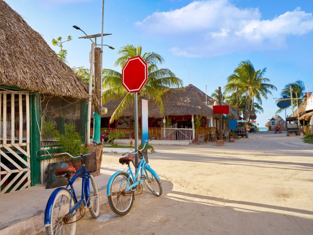 Bikes parked along dirt road on Isla Holbox, Mexico