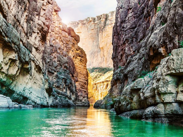 Greenish waters of the Rio Grande flanked by narrow and steep canyon walls